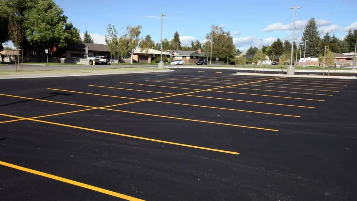 A parking lot with yellow lines on the side of it.